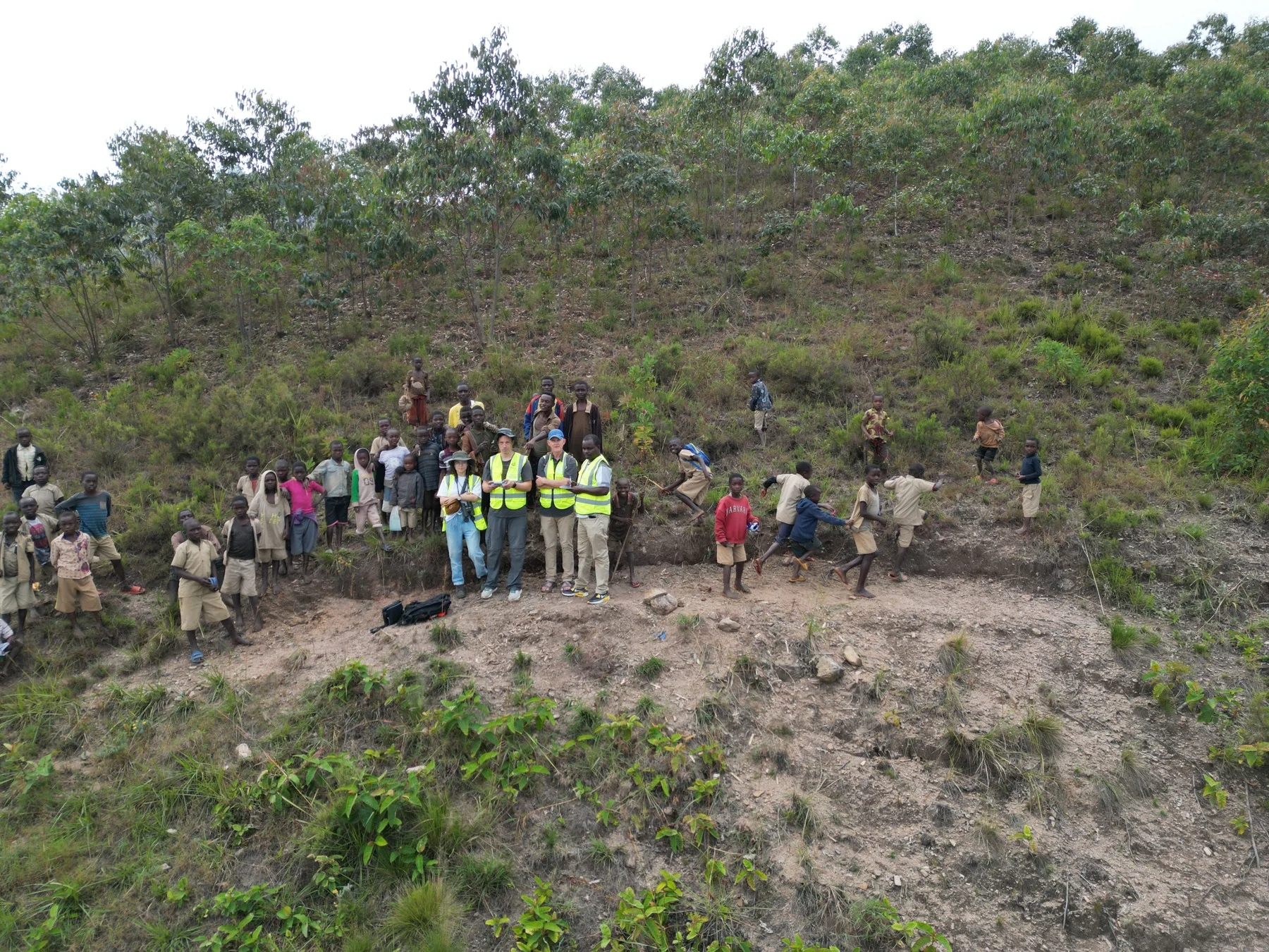 A group gathered on a hillside during a hydropower site visit in Burundi